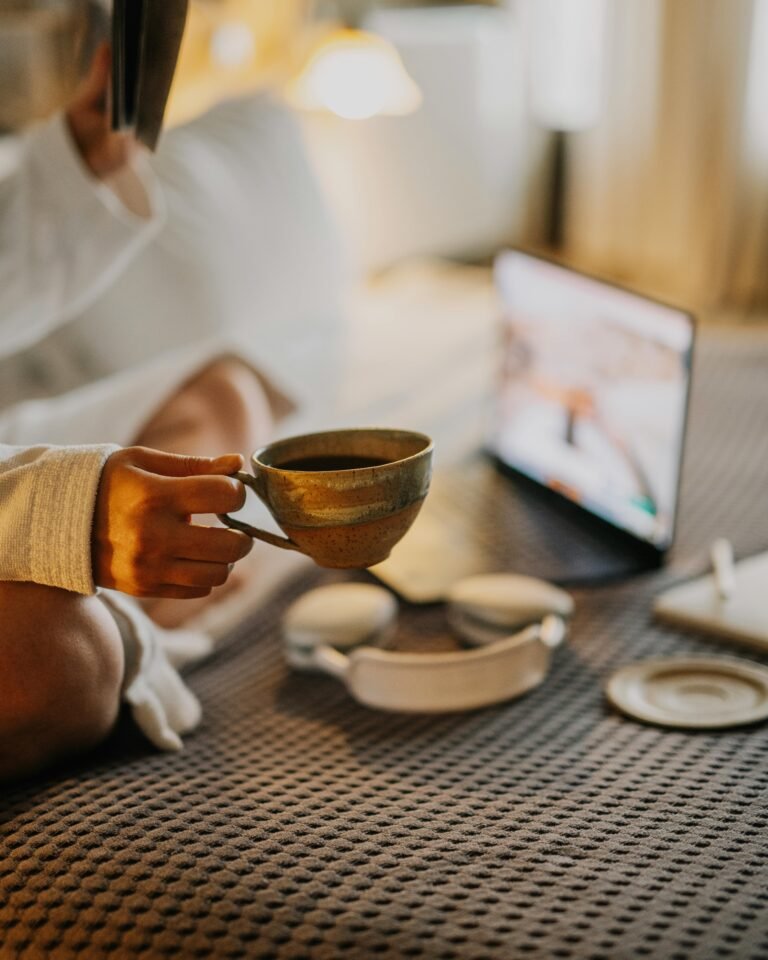 A relaxing morning scene in a hotel room featuring a cup of coffee and a tablet, perfect for unwinding.